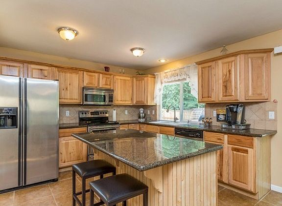Slab Granite, Stainless Steel Appliances and beautiful, abundant