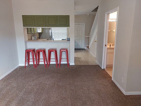 View of living room/dining area. Half-bath is visible to the right.