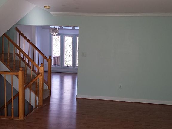 Middle floor: view from the Living Room to the Dining Room. upper staircase to 3 beds, 2 baths, and a linen closet. 
Staircase to the basement. Rec room, full bathroom, Laundry room with ample storage space, and a small one under the staircase.