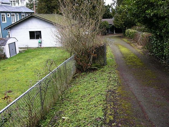 Driveway to home with garden space, 4 car garage, storage building & carport!