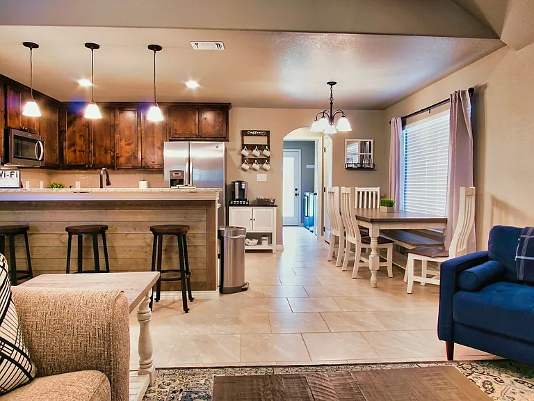 Comfortable open-concept living room flowing seamlessly into the dining area and kitchen.