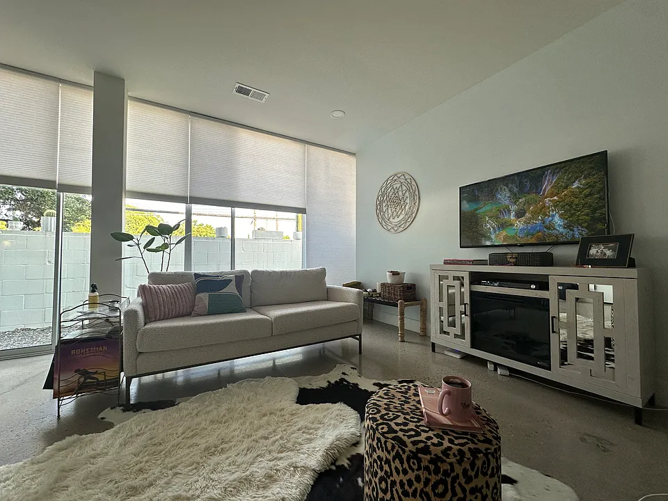 Automatic floor to ceiling powered blinds are light and sound filtering.