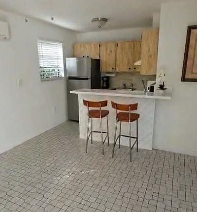 Living room facing kitchen/bar countertop