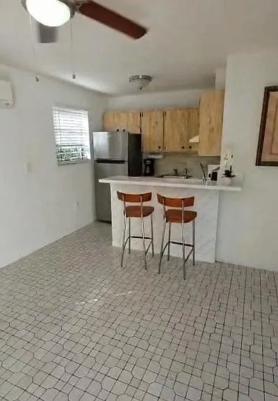 Living room facing kitchen/bar countertop