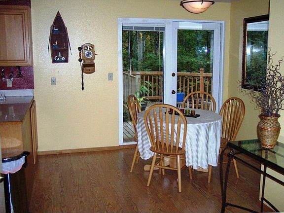 The dining area is just off the kitchen and opens to the custom deck and back yard.