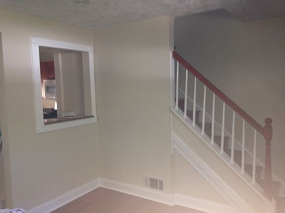 Living room stairs and open space to kitchen