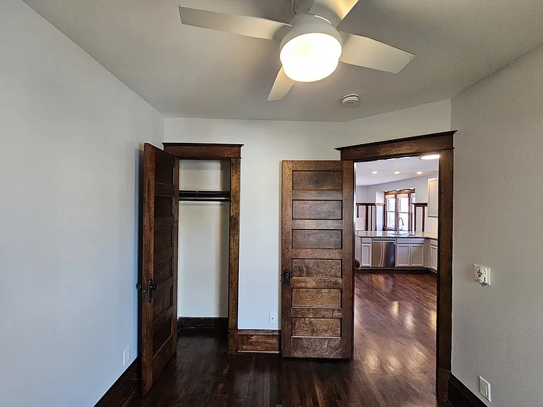 ack bedroom is connected through the kitchen. Room measures 106"x113" with closet and ceiling fan. Bedroom window view is the unit's private rear porch and backyard.