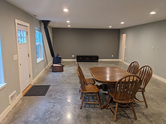 Comfortable living room with wood stove. Owner supplies wood at no cost to tenant.