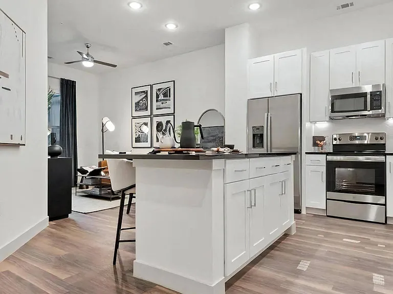 Apartment Interior with White Cabinets and Combined Living Space