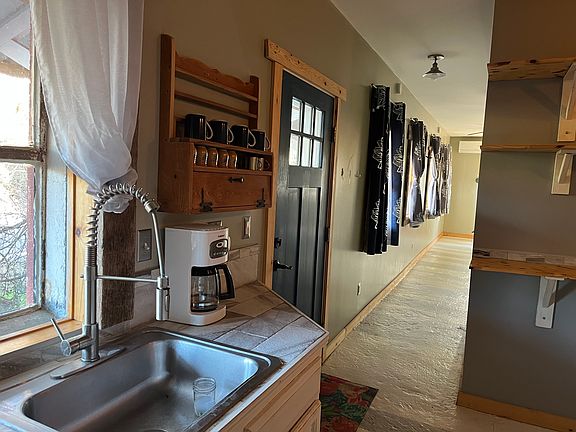 into kitchen looking down hallway to the living area and bedroom
