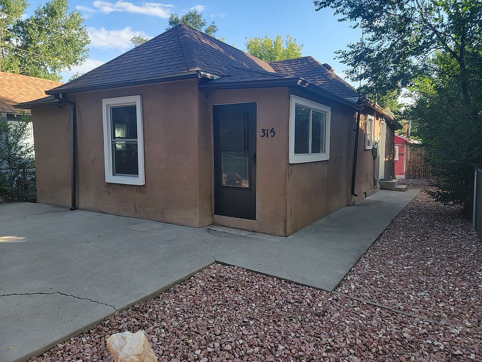 Front of house with landscaped and fenced in yard