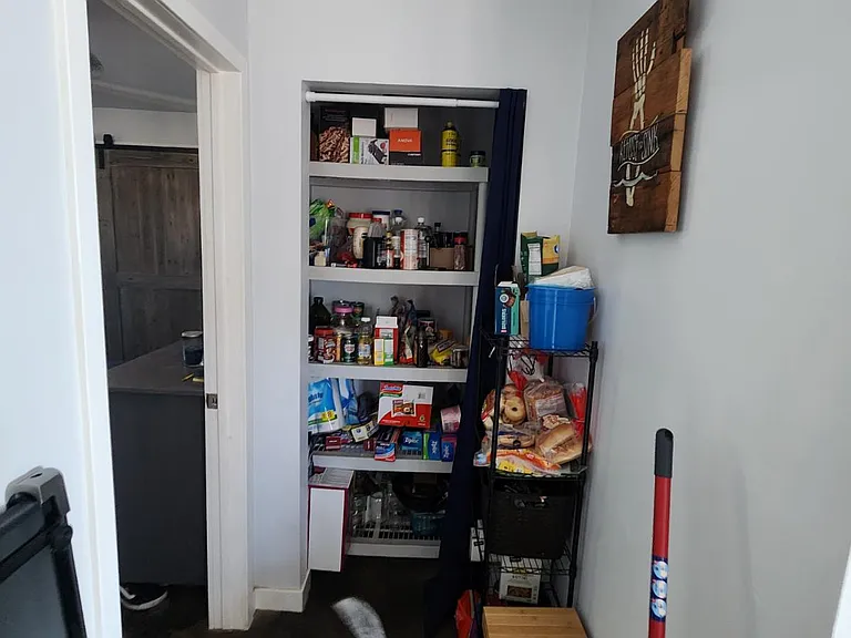 hallway has a pantry/storage area