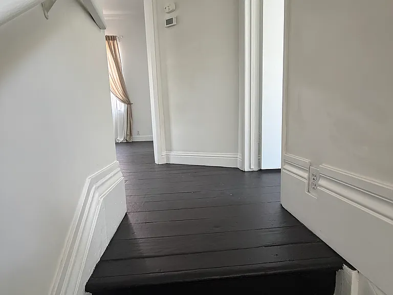 Stair landing with entry to the bonus room on the right, Bedroom 1 on the left, and the dining room directly ahead.