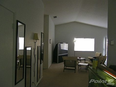 Living room with vaulted ceilings.