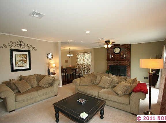 View of fireplace, living room & kitchen eating area