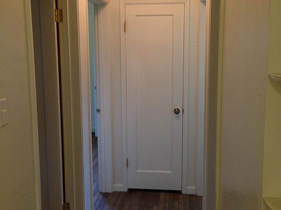 Hallway from Kitchen to the bedrooms and bathroom, access to attic