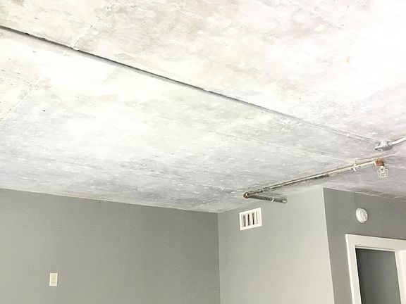 Concrete ceilings with exposed pipes