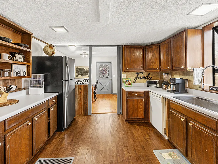 Kitchen has pots, pans, dual drip/pod coffee maker and large fridge