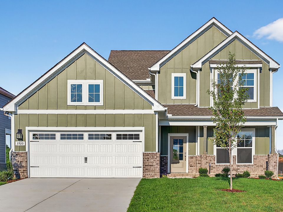 Exquisite McClure Farms residence featuring stylish green facade, classic brickwork, pristine garage