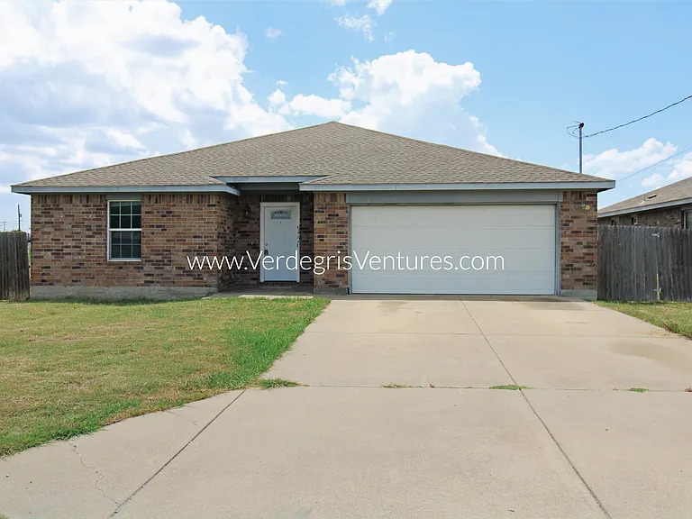 Exterior view, attached 2 car garage and additional parking for 2 vehicles in driveway