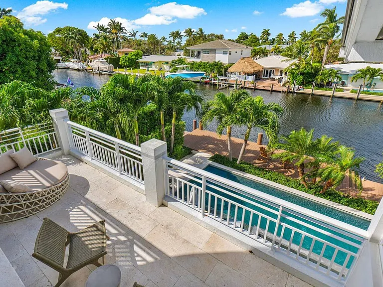 Private balcony with serene views of the pool and canal, ideal for peaceful mornings and quiet afternoons.
