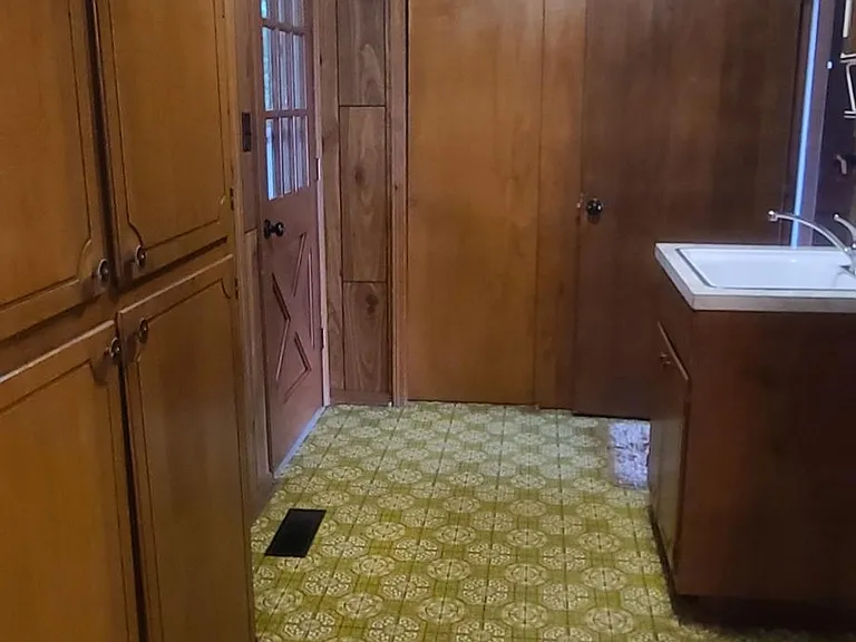 Laundry Storage Cabinets & Closet
Back Door onto Covered Porch