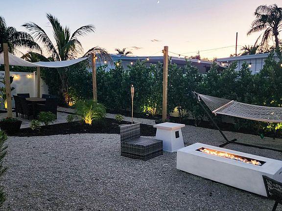 Enjoy your private, back yard with fire pit, hammock and dining area.