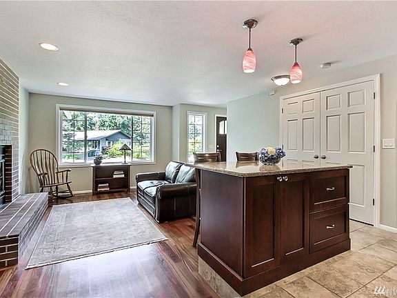 View from kitchen to front of home, large picture window & entry. 