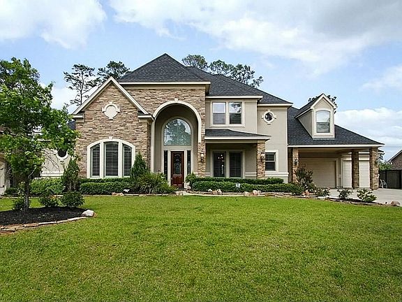 Stone and stucco accentuated by lush landscaping make this home especially appealing.