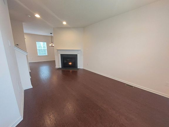 Open space layout of living + dining with gas fireplace