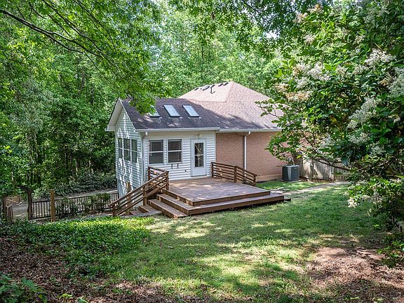 Side yard decking off of sunroom. Side yard is fenced is gate to driveway is closed.