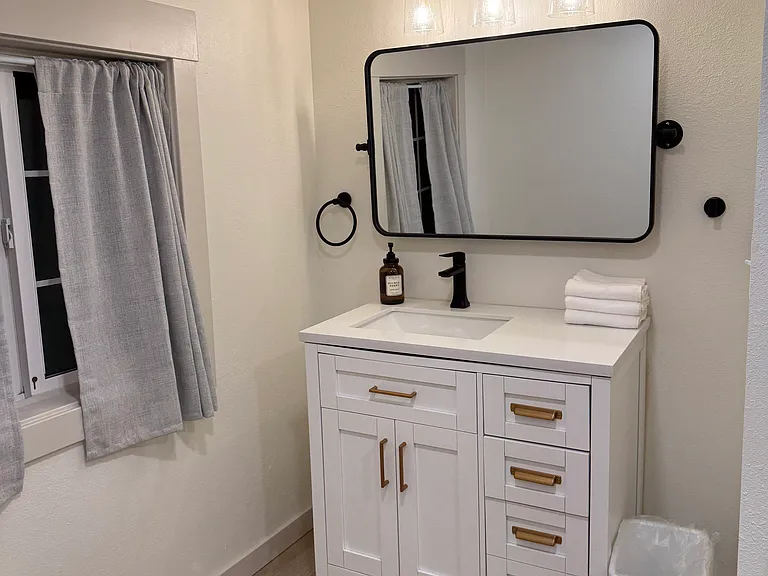 Main bathroom adjacent to pantry area.
