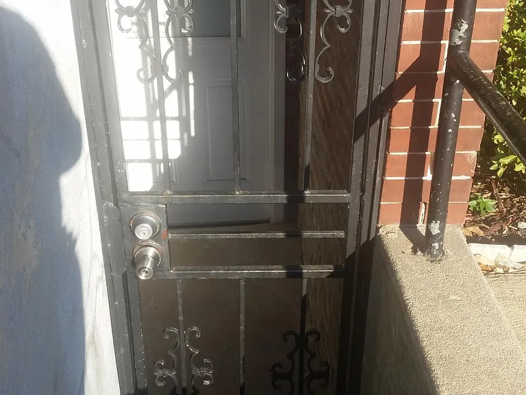 Front entrance - iron security gate + outside front door