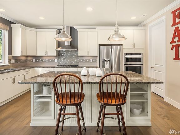 An abundance of custom cabinetry and elegant quartz counters.