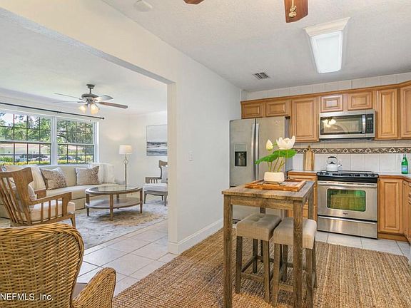 Kitchen. Connects to living room, dining, and sitting area with fireplace.