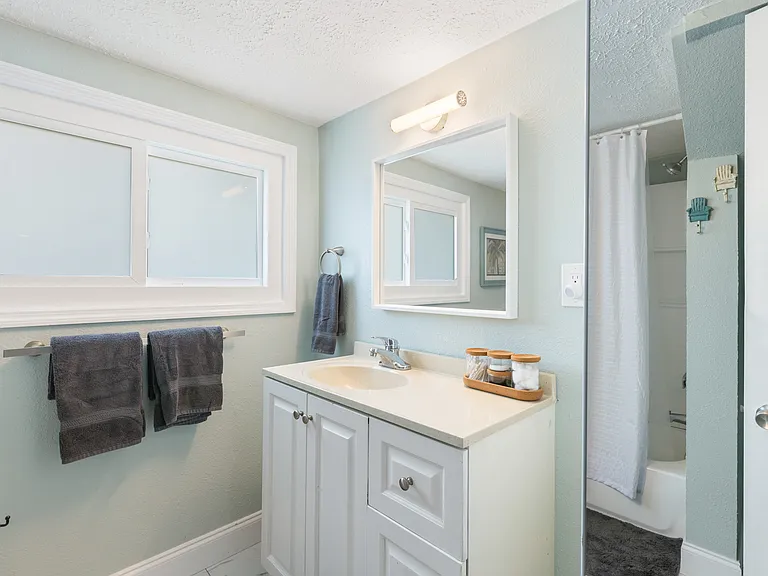 Full bathroom with added linen closet for extra storage and organization.