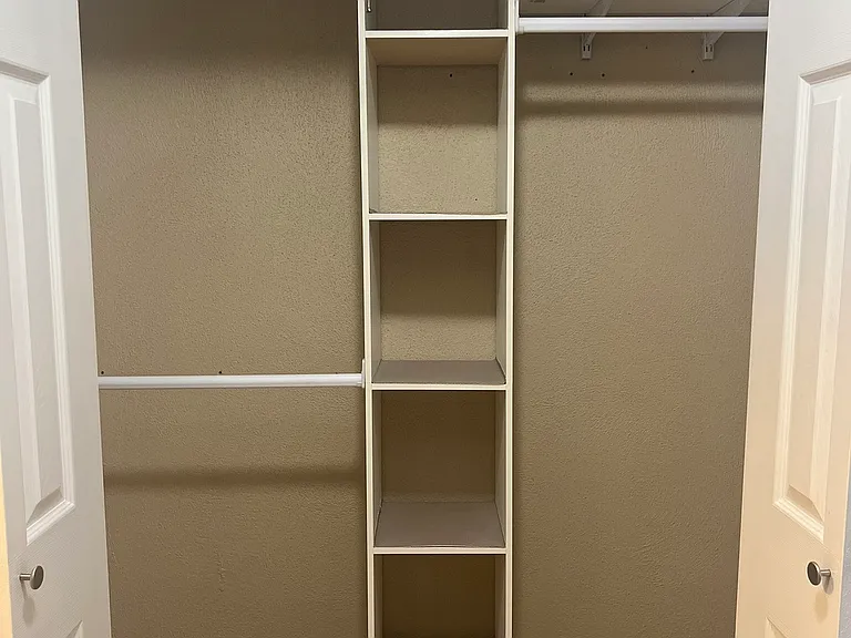 primary closet built in shelving (empty)