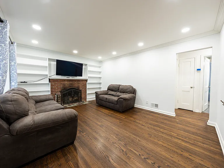 Living room with fireplace and built-in shelving