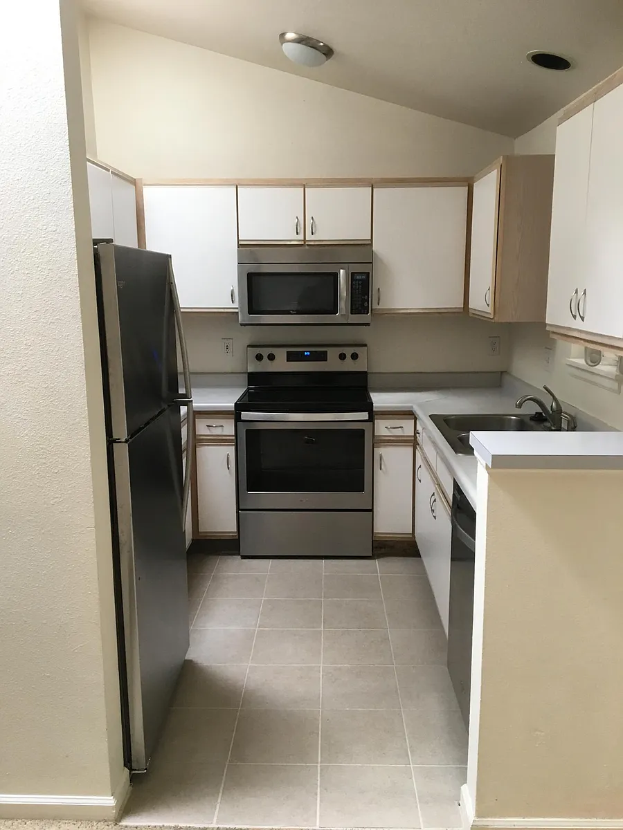Kitchen with new stainless steel appliances and tile. - 4410 Laguna Pl #I
