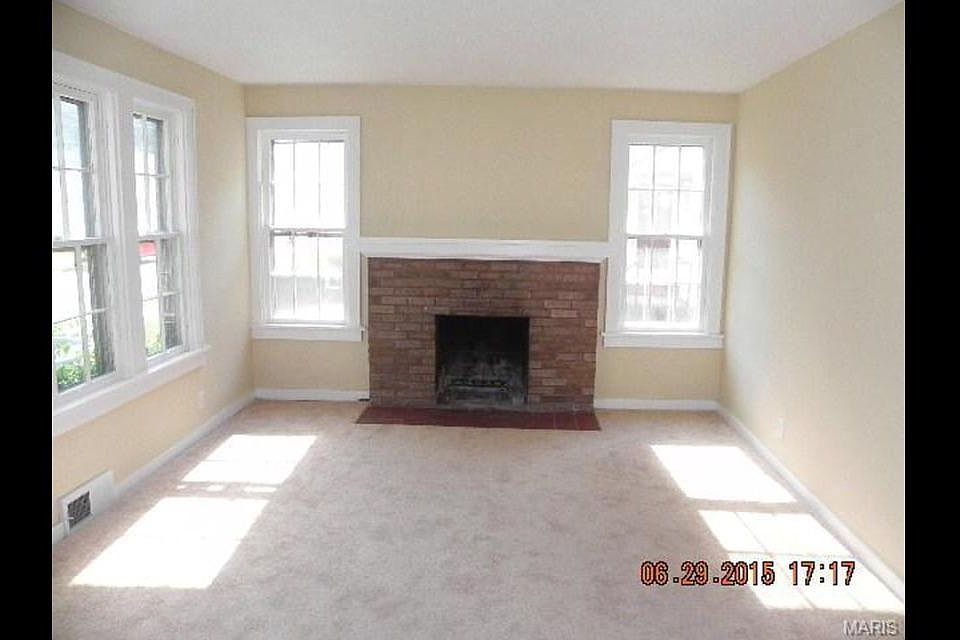 Living room comes with an electric fireplace insert.