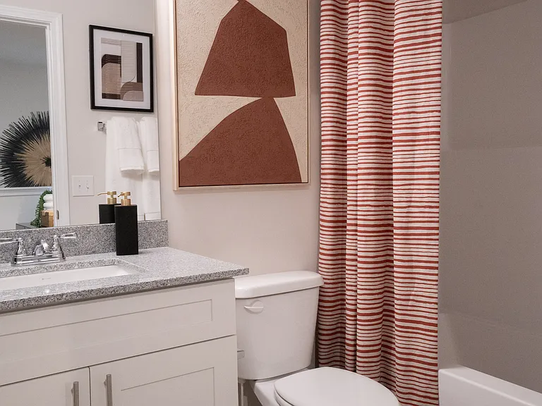 Secondary bathroom on the second floor, with tub shower and single vanity.