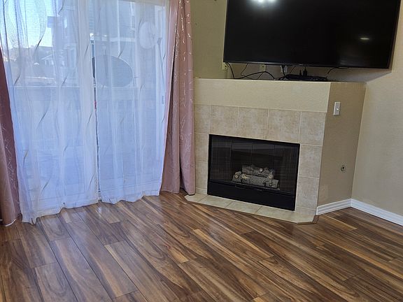 Living room with a gas fireplace and a patio entry