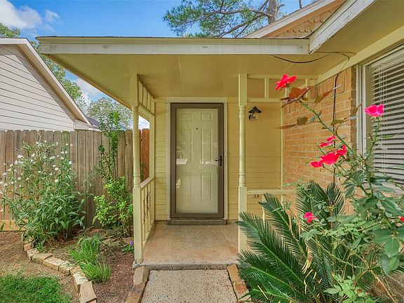 Covered porch with glass storm door.