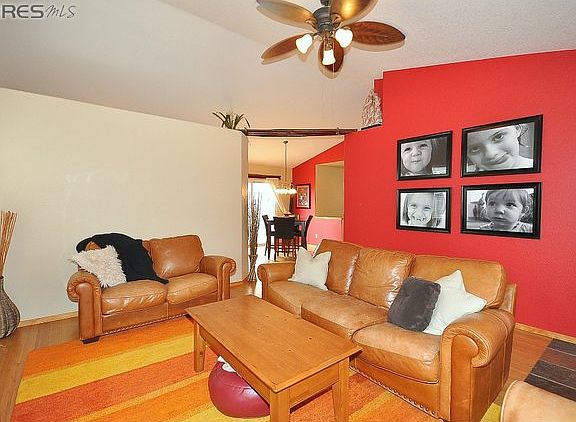 Family Room w/ accent wall & wood flrs