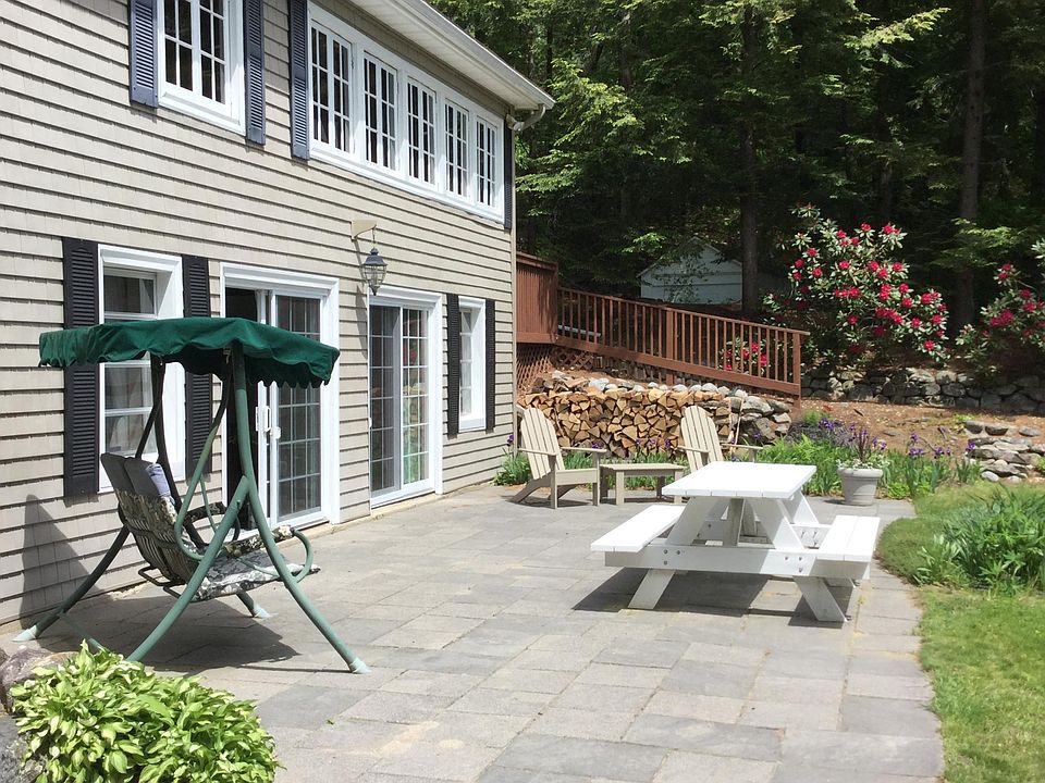 Step out of the apartment onto a large patio with Adirondack chairs, a grill, picnic table and a patio swing.