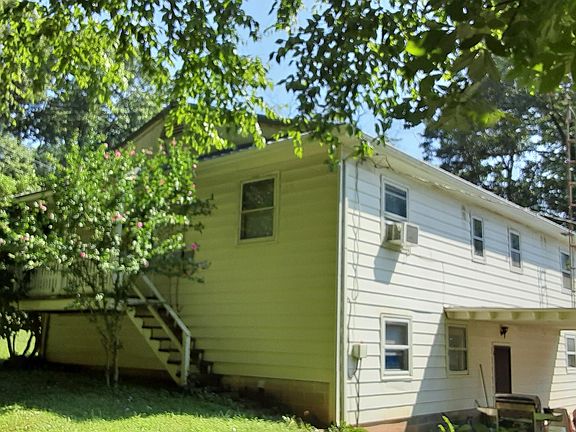 N Side/back of house showing little kitchen porch and back covered deck