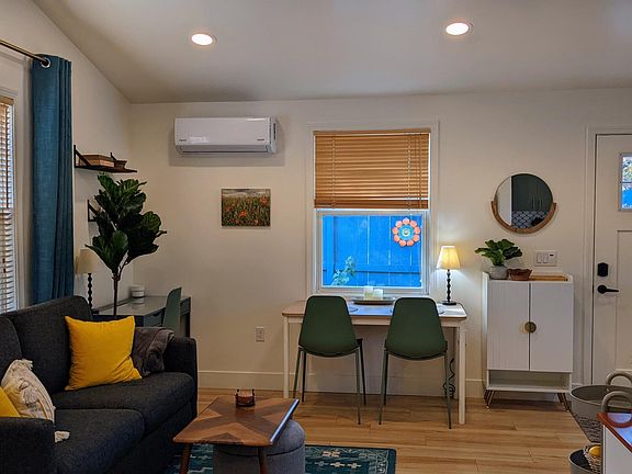 Main Living Space with dedicated desk area, dining area, and a pull-out sofa bed