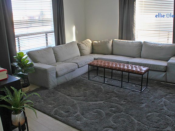 Living room includes large sofa and 55" TV