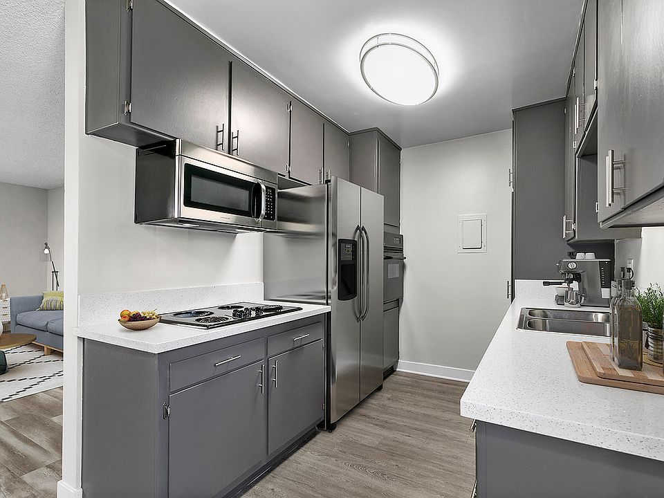 Spacious kitchen with stainless steel fridge, oven, and microwave.