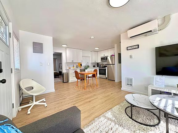 Newly furnished dining area with island seating, perfect for meals or morning coffee.